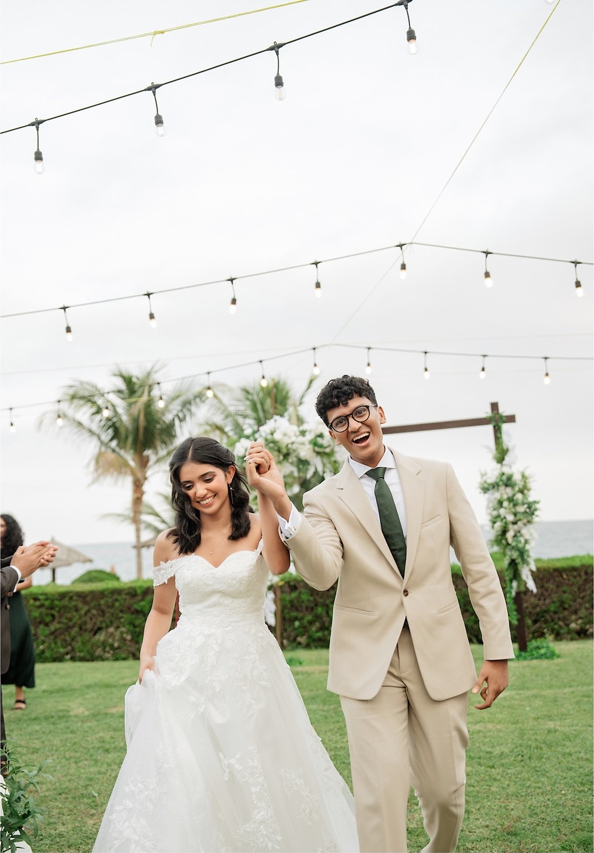 A newlywed couple walking together after their ceremony